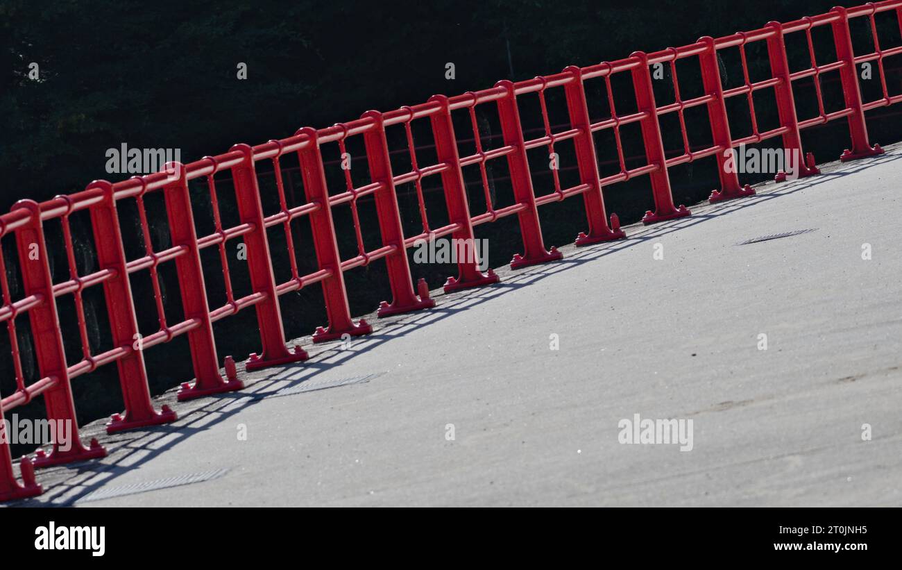 Abstract photography of red safety fence on the dam wall. Water reservoir Bystricka, Czech republic. Stock Photo