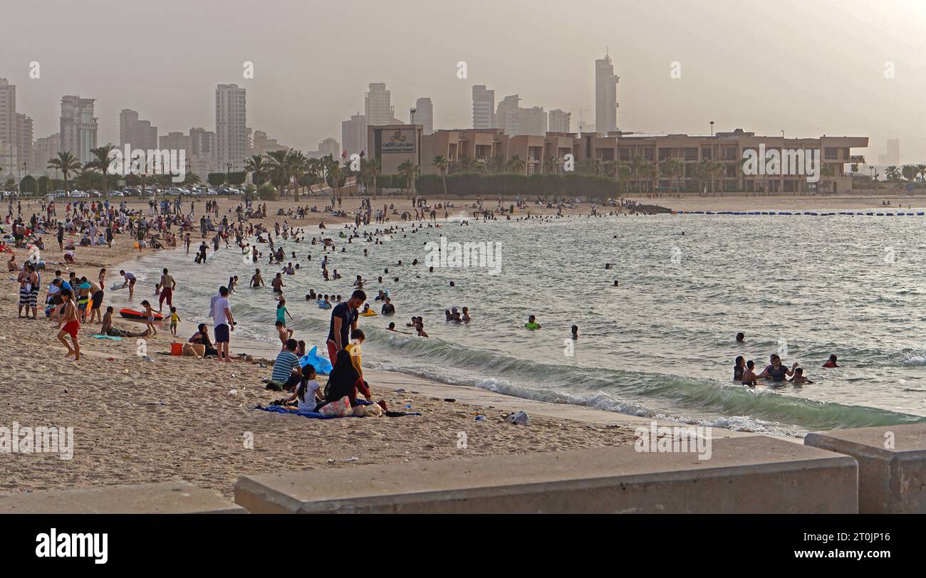 Kuwait City, Kuwait - June 22, 2018: People at marina beach at Persian gulf coast warm summer day travel vacation. Stock Photo