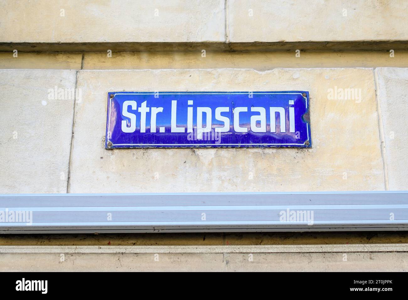 Beautiful vintage street sign showing Strada Lipscani (Lipscani Street) displayed on an street in the old city center of Bucharest, Romania, in a sunn Stock Photo