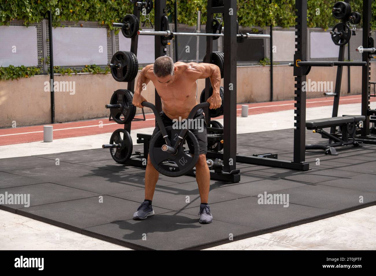 Mature man doing workout in a sunny day Stock Photo