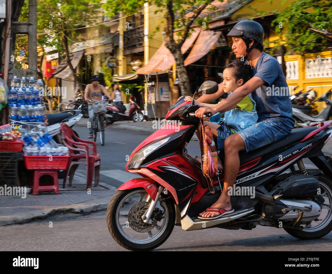Hoi An, Vietnam. Father and Daughter on Motorbike. Stock Photo