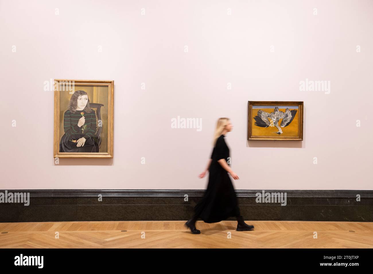 A member of the gallery staff walking past two Lucian Freud paintings at the press opening for the Lucian Freud: New Perspectives exhibition at The Na Stock Photo