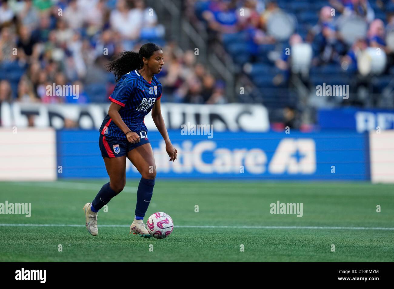 OL Reign defender Ryanne Brown moves the ball against the Washington