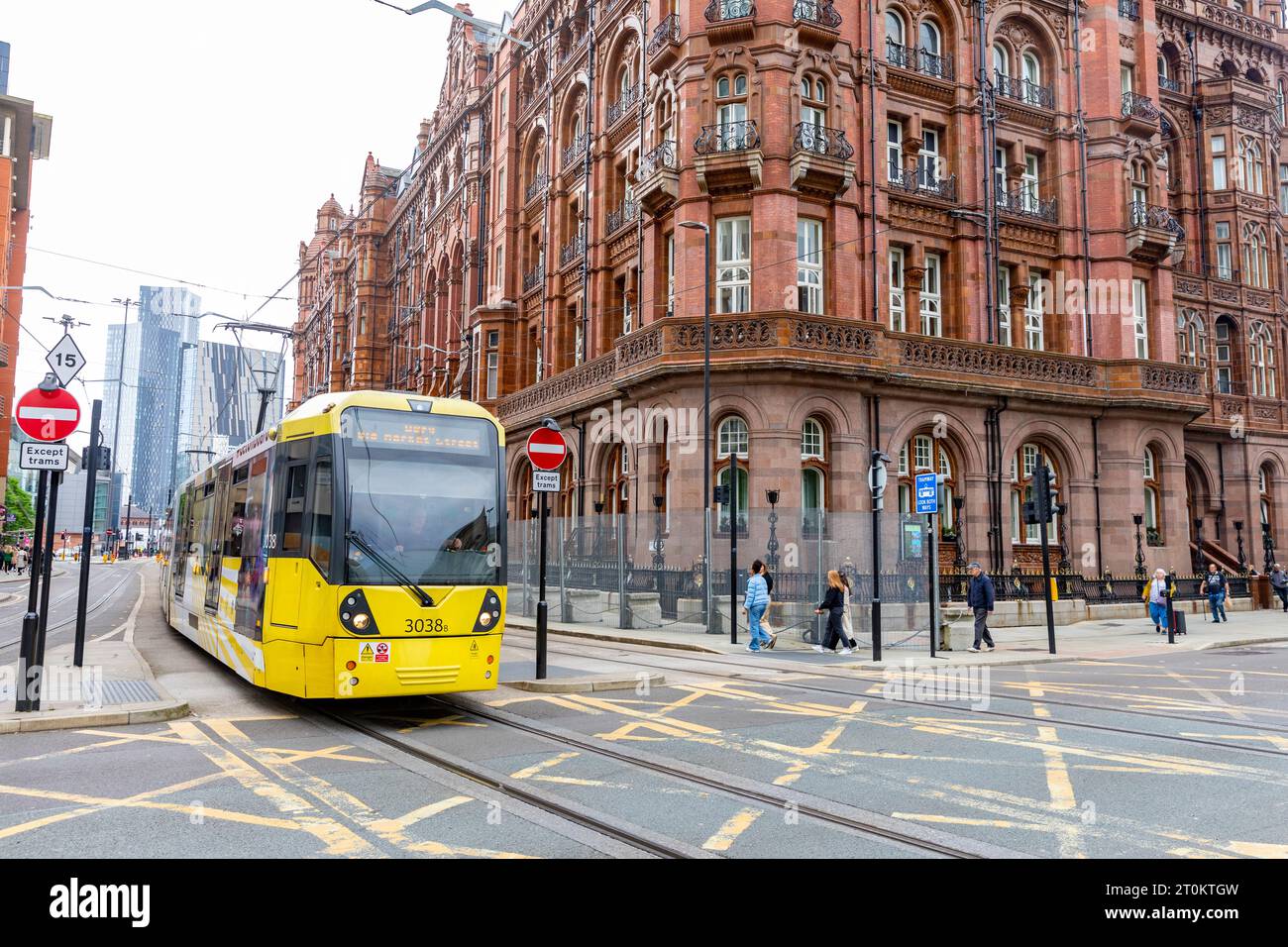 Manchester yellow tram in the city centre passes by the the Midland Hotel, Greater Manchester,England,UK,sept 2023 Stock Photo