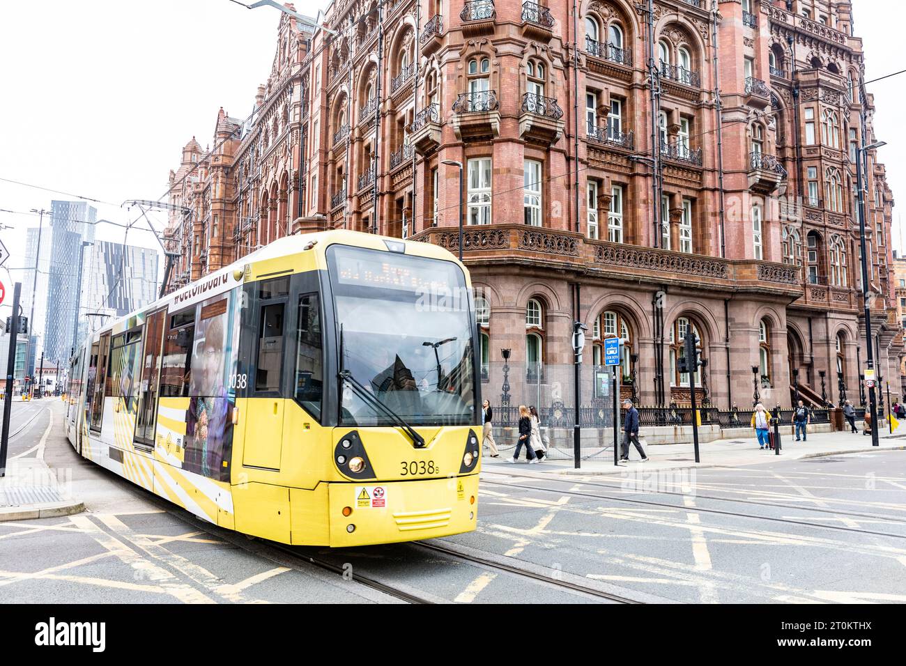 Manchester yellow tram in the city centre passes by the the Midland Hotel, Greater Manchester,England,UK,sept 2023 Stock Photo