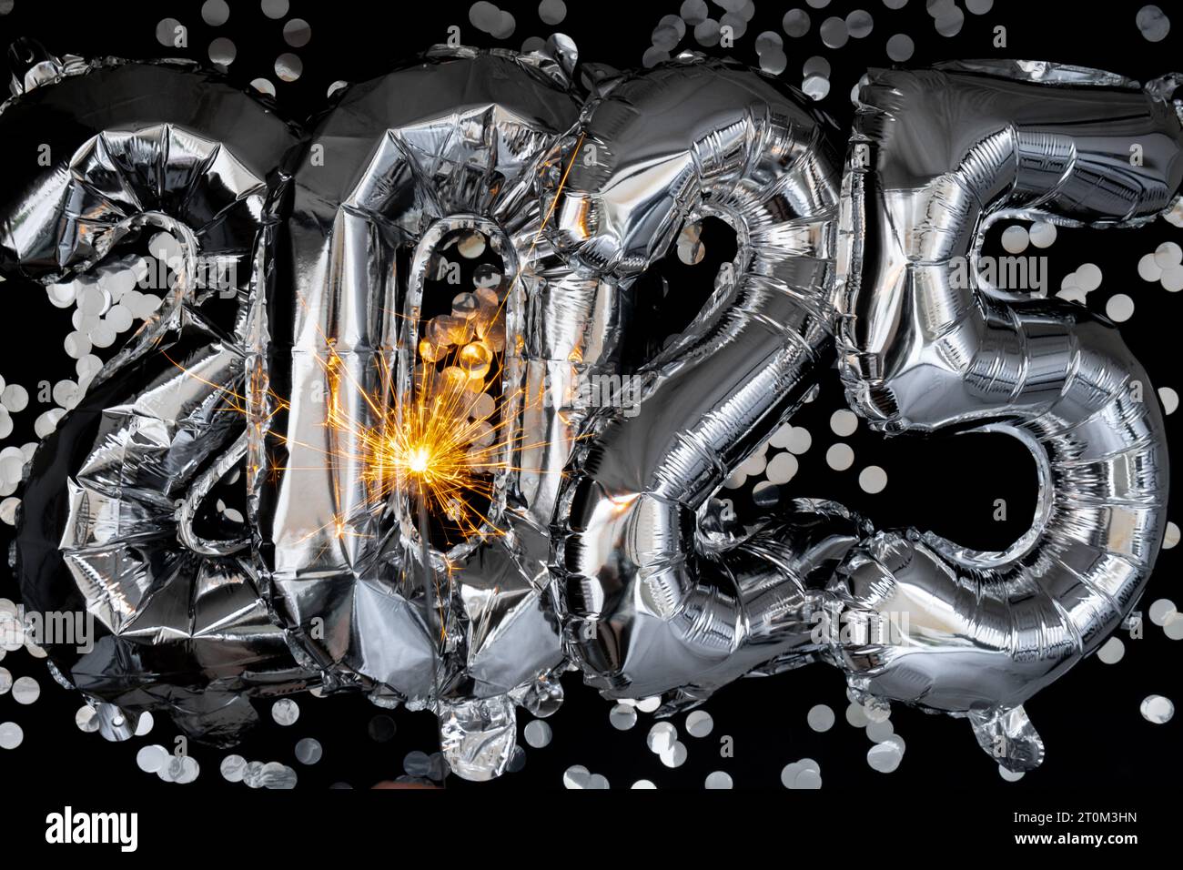 Happy new year 2025 metallic balloons with confetti and sparkler