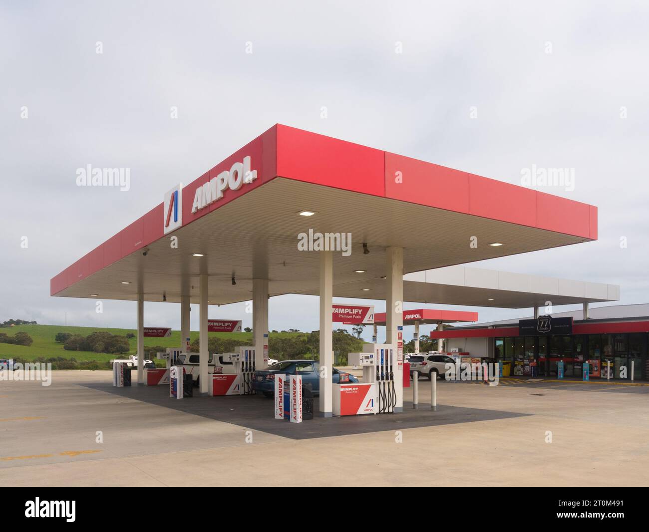 Exterior view of Ampol service station in the Fleurieu Peninsula with green hills in background in South Australia, Australia. Stock Photo