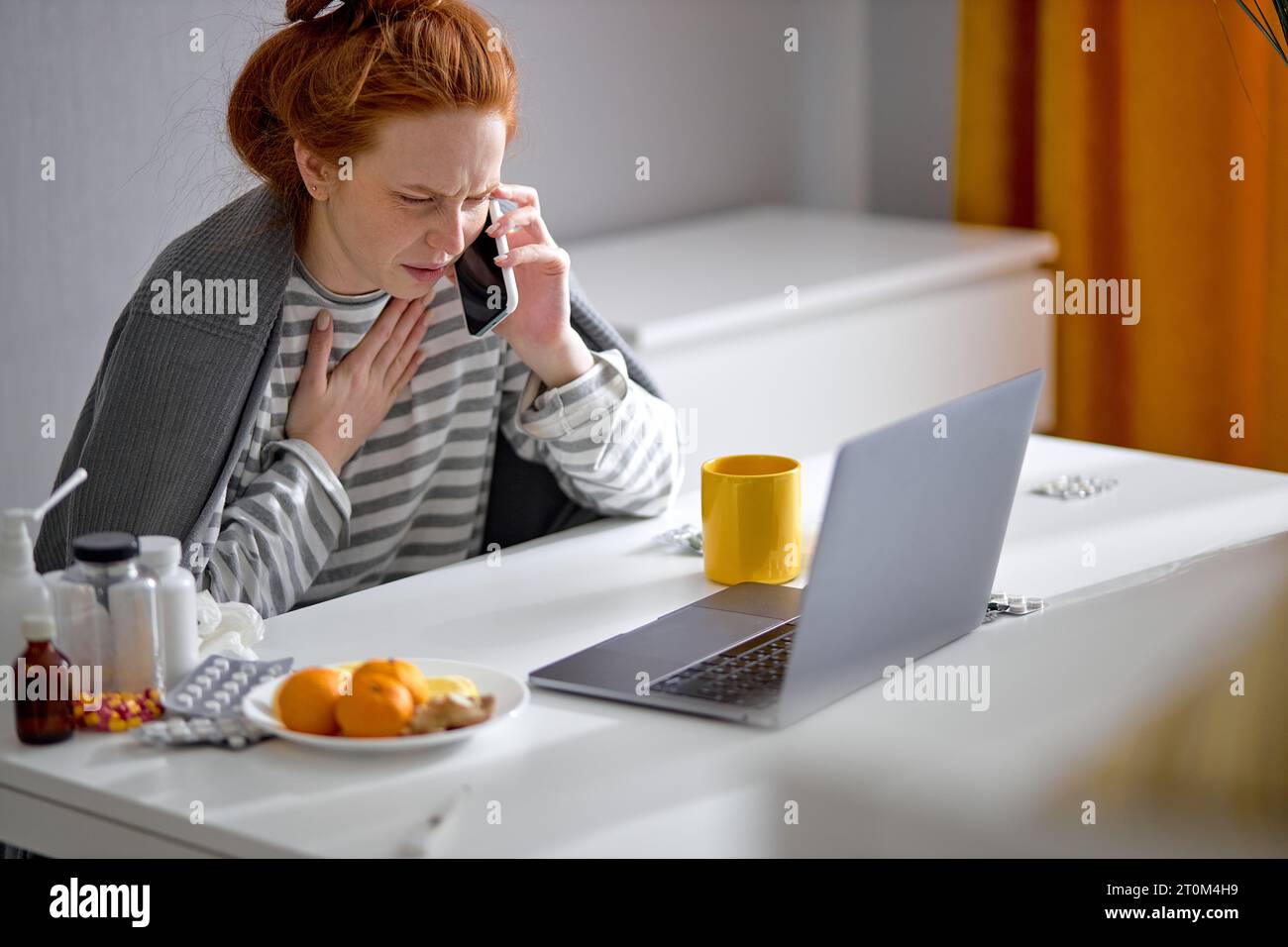 sick frustrated angry redhead girl making phone call to friend, family, doctor, complaining about her terrible illness, close up side view portrait co Stock Photo