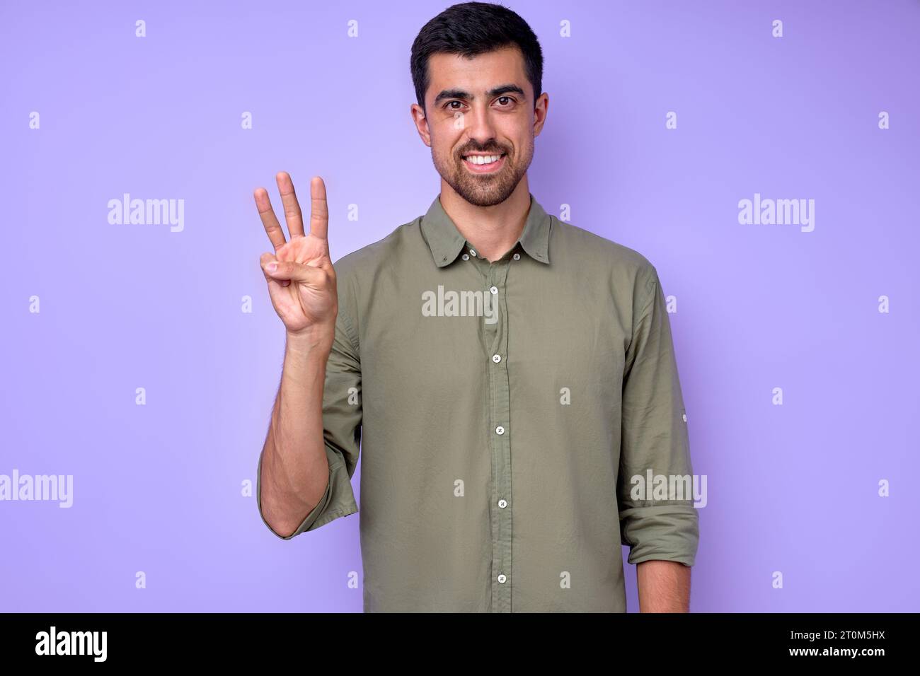 cheerful brunette bearded man demonstrating the letter W w . sign ...