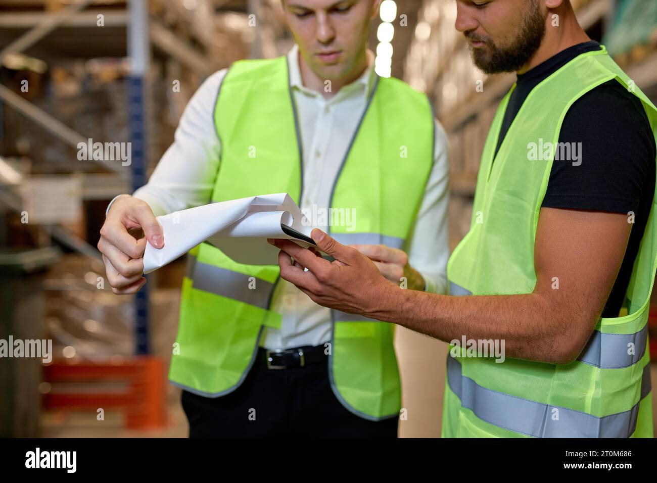 cropped warehouse managers in work wear organizing distribution in