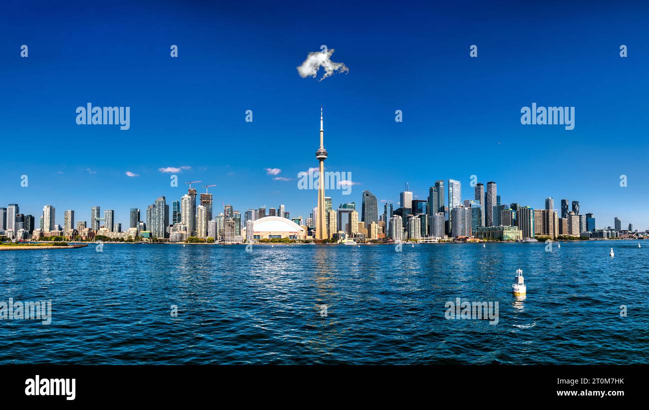 A scenic view of The Toronto skyline and CN Tower under the blue sky ...