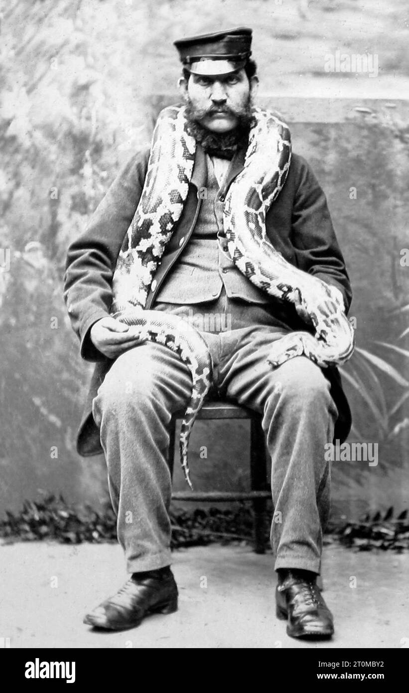 Keeper with snake at London Zoo, Victorian period Stock Photo - Alamy