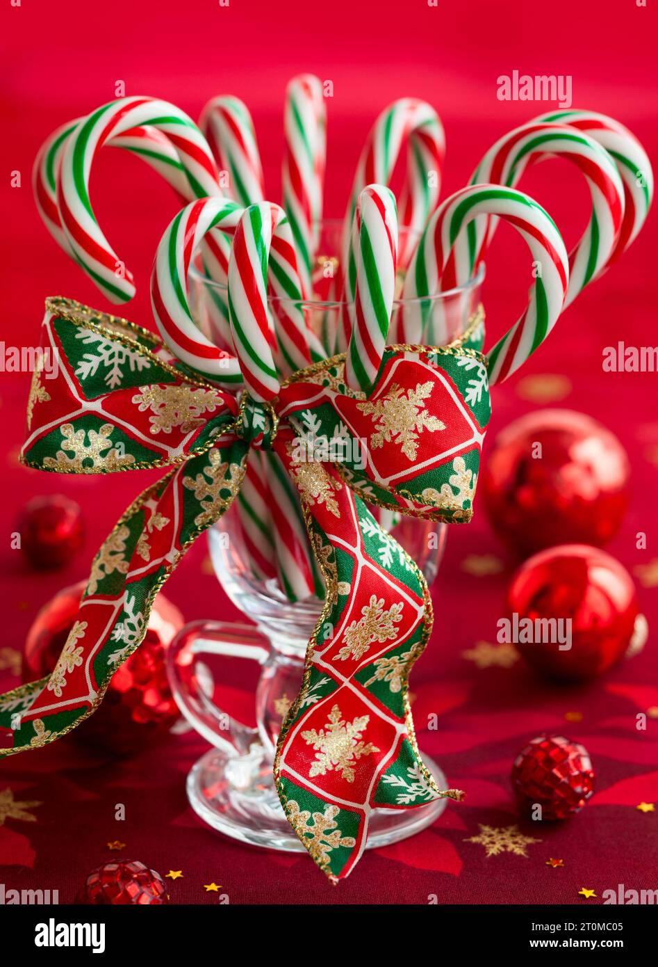 Candy canes in a glass on red background Stock Photo - Alamy