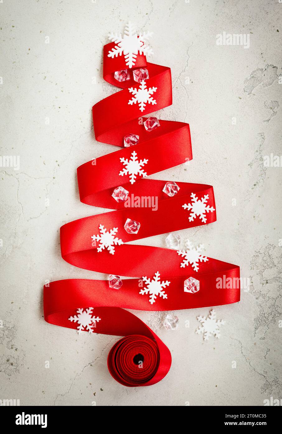 Red Ribbon Christmas Tree with decor on the cracked vintage background