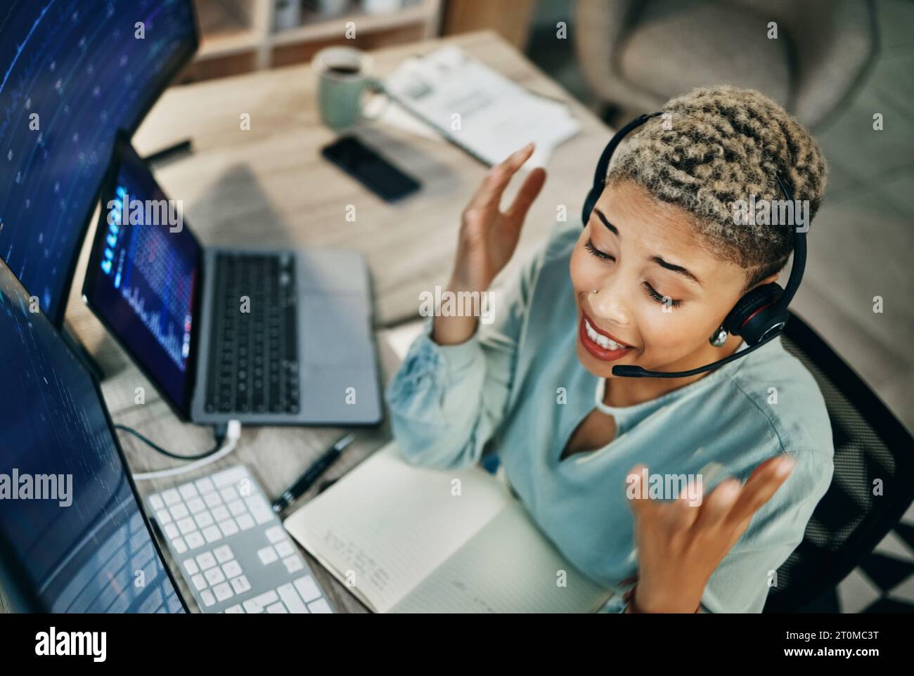 Woman, online trading and call center, computer and finance with advice, top view and excited or data about investment. Headset, mic and business with Stock Photo