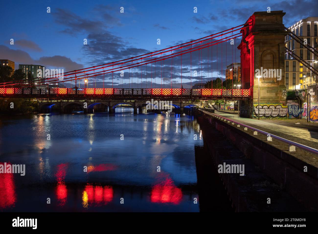 The South Portland Street Suspension Bridge at night, footbridge across the River Clyde in city of Glasgow, Scotland, UK. Stock Photo