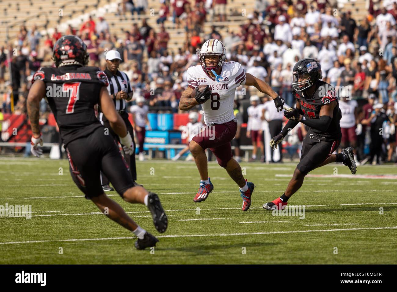 Texas State Bobcats running back Donerio Davenport (8) carries as he is pursued by Louisiana-Lafayette Ragin Cajuns linebacker Ja'Marian Peterson (15) Stock Photo