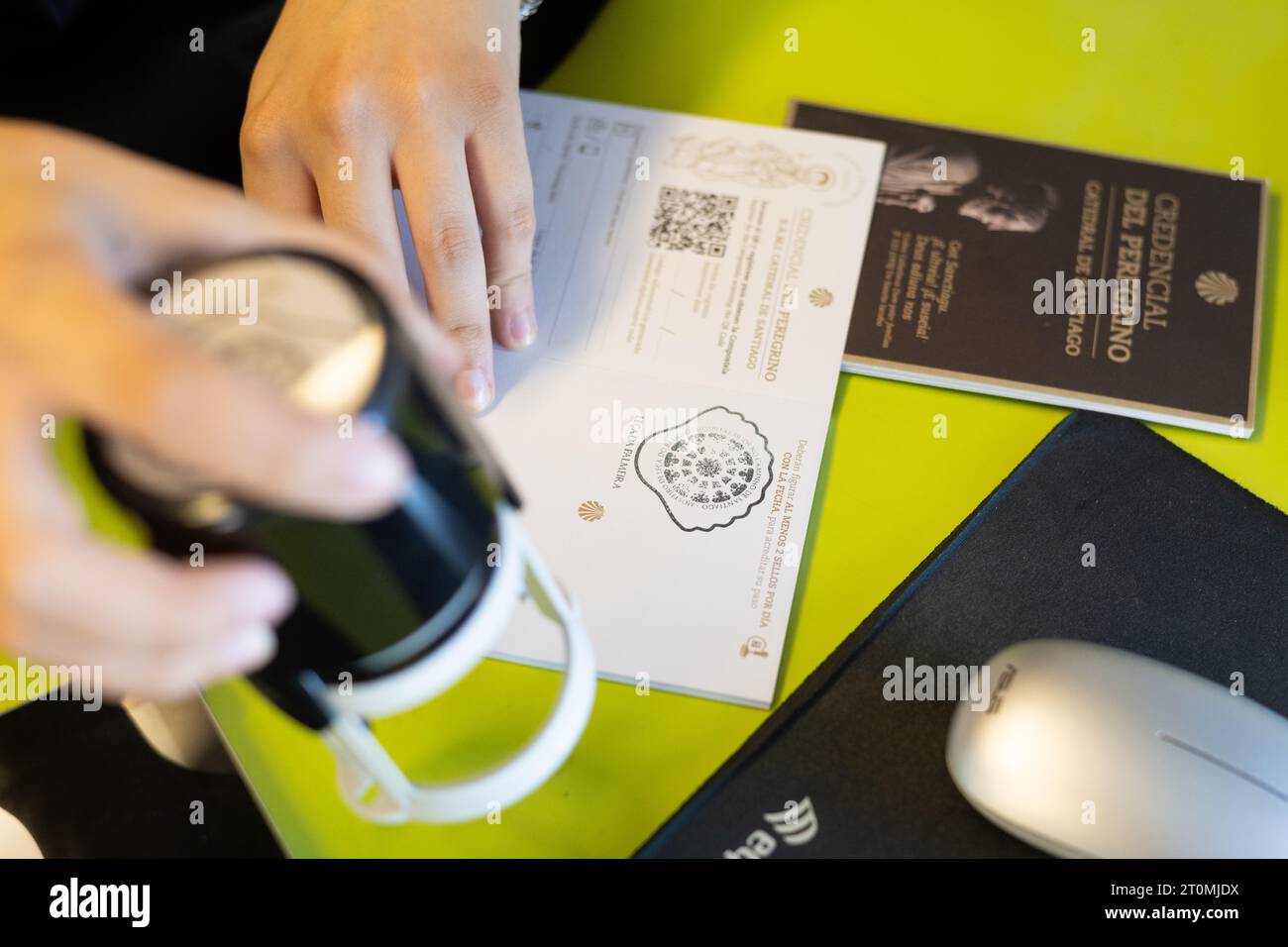 Camino Pilgrim Passport or Credencial being stamped in tourist information office on the Portuguese coastal way, Portugal Stock Photo