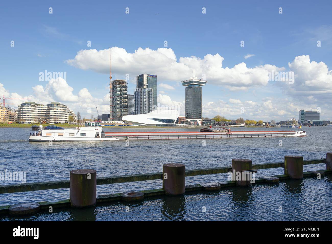 Amsterdam, Netherlands - EYE Filmmuseum by Delugan Meissl Associated Architects, across river Ij with barge Stock Photo