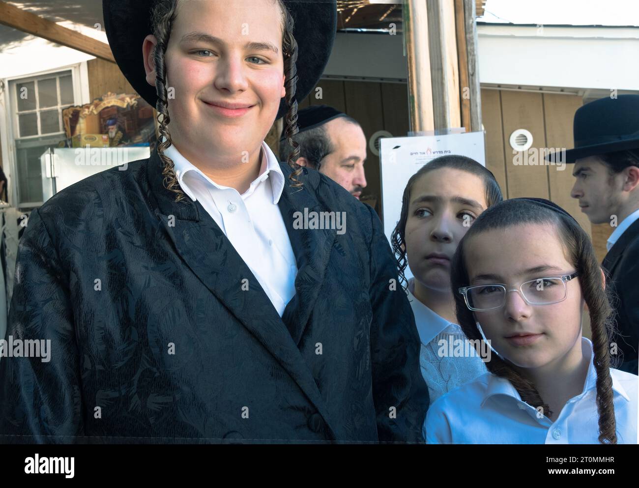 A group of orthodox Jewish men and boys inside a Sukkah during Sukkos. In Rockland County, New York. Stock Photo