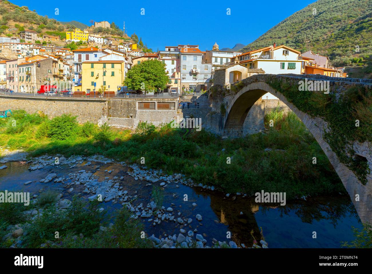 Medieval stone bridge over Argentina river and chapel in small town Badalucco. Badalucco is a comune in the Province of Imperia in Italy. Stock Photo