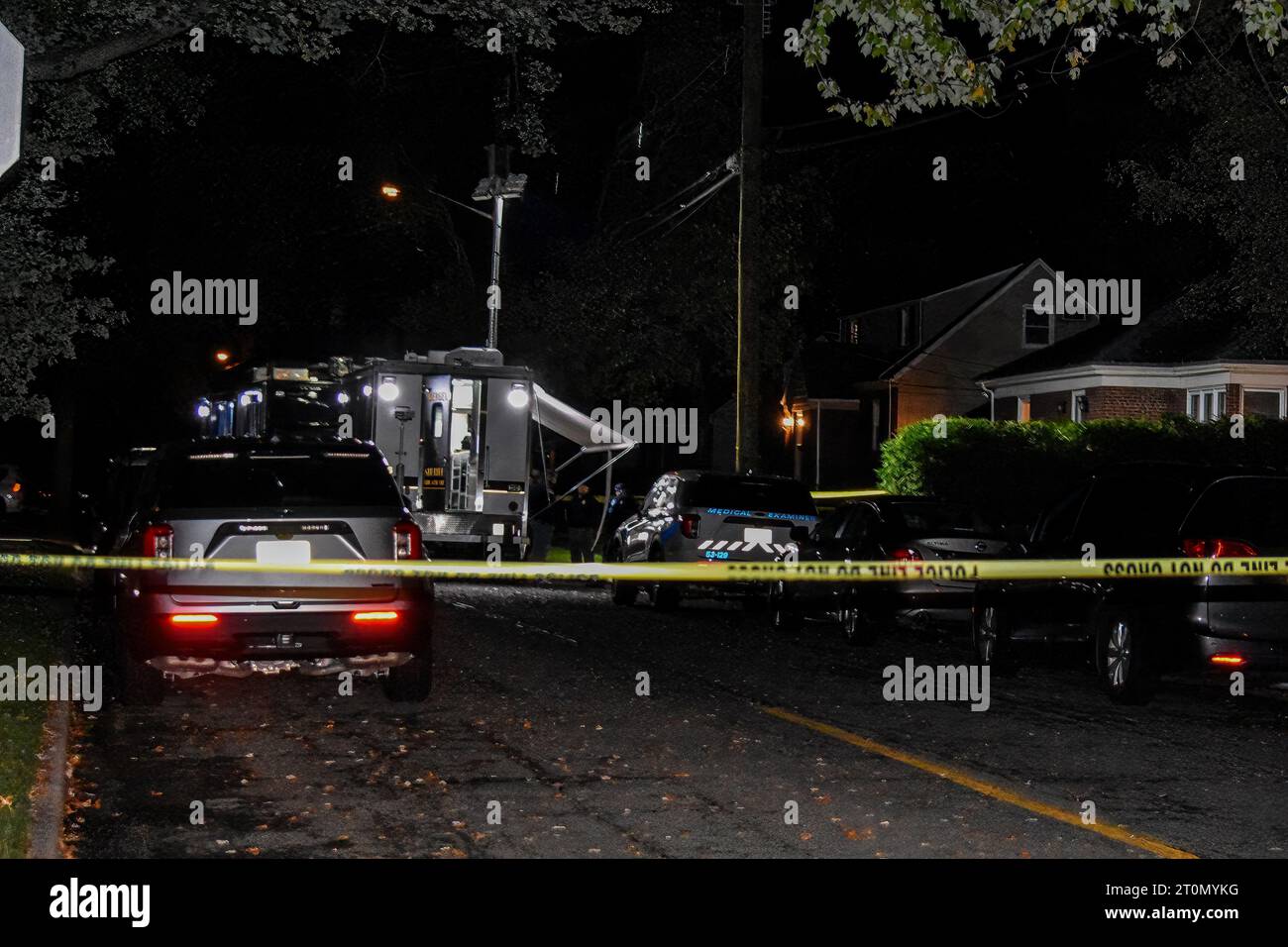 Officials gather and collect evidence from the crime scene. Two people