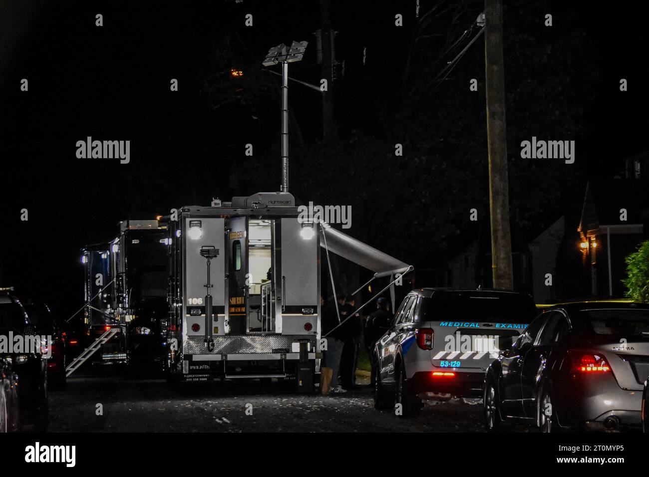 Officials gather and collect evidence from the crime scene. Two people