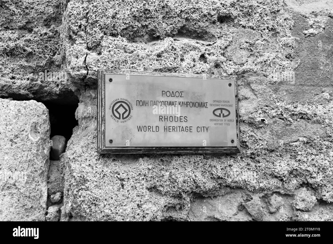 Rhodes World Heritage City sign hung at the Gate of Amboise entrance to Old Town, Rhodes in black and white Stock Photo