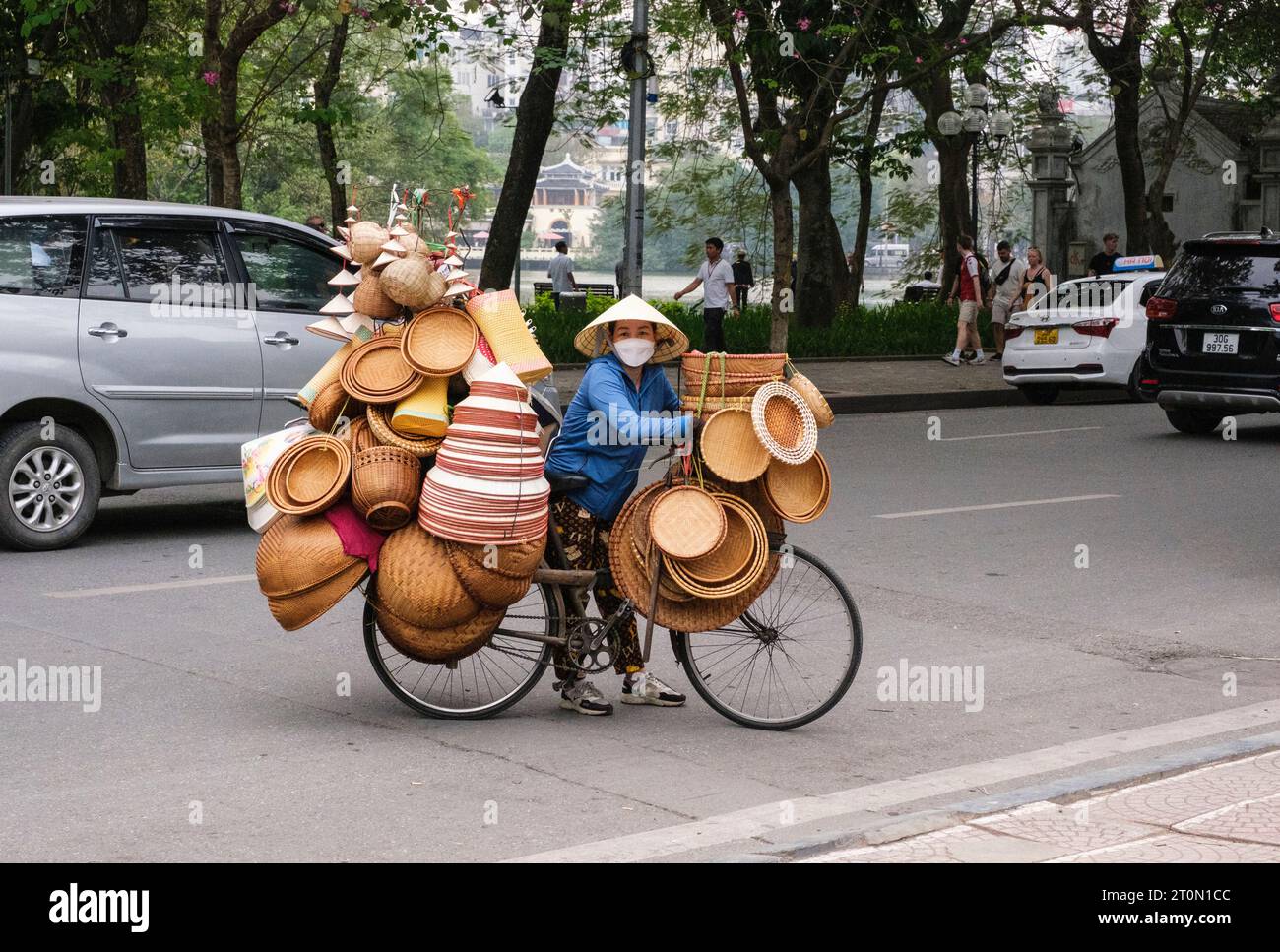 Hanoi, Vietnam. Basket Vendor on Busy Hanoi Street. Stock Photo