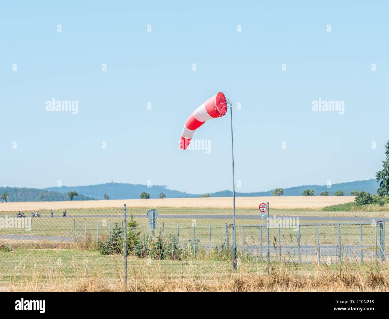 Summer hot day on sport airport with abandoned windsock, wind is blowing and windsock is moving Stock Photo
