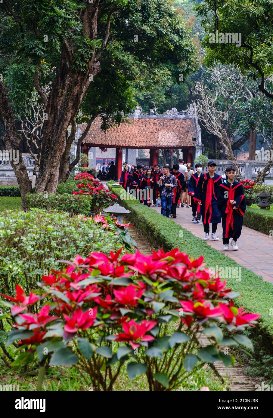 Hanoi, Vietnam. Temple of Literature, Van Mieu,  Dedicated to Confucius. Students Coming from Graduation Celebrations. Stock Photo
