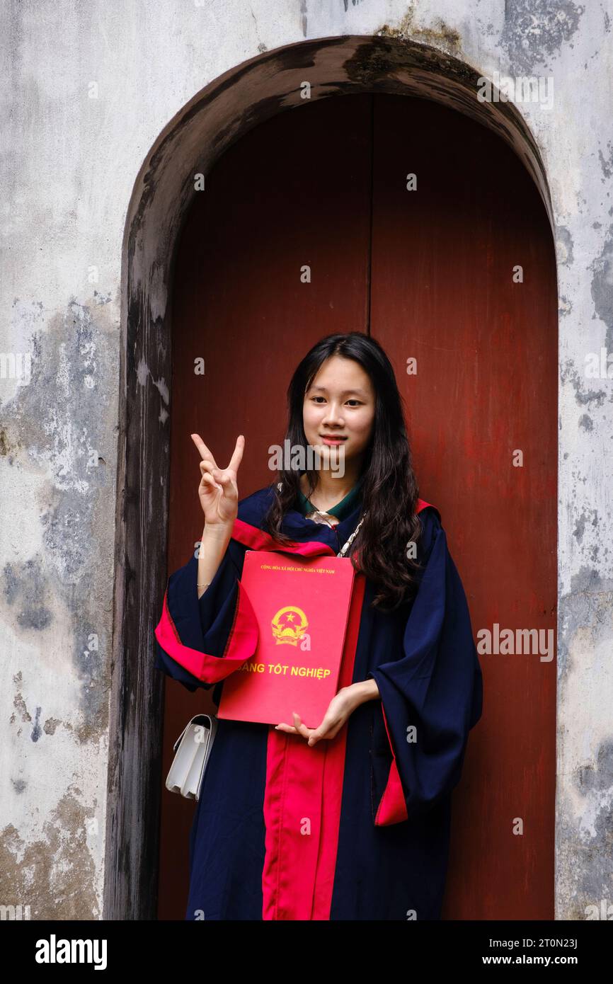 Hanoi, Vietnam. Temple of Literature, Van Mieu. Young Woman Student Holding Graduation Certificate. Stock Photo