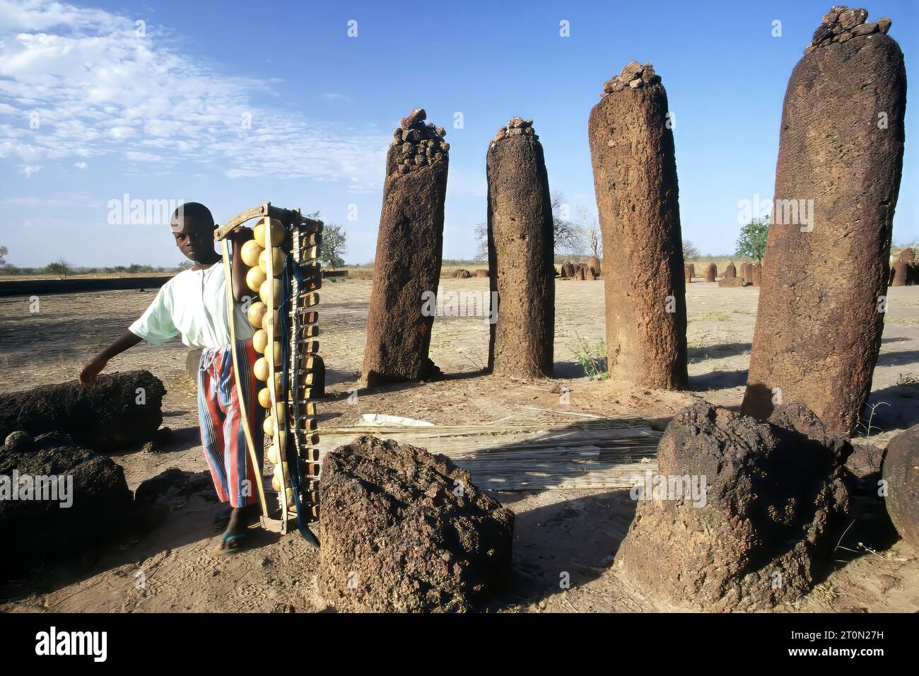 A boy carries an traditional balafon music instrument at the Wassu Stone Circles, UNESCO World Heritage Site, the Gambia, Africa Stock Photo