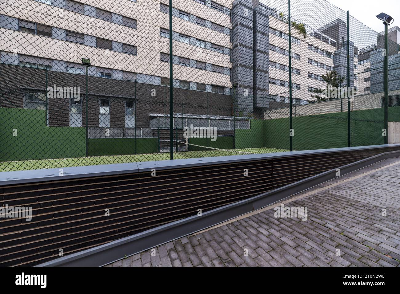 Paddle tennis court closed with metal fences and painted completely