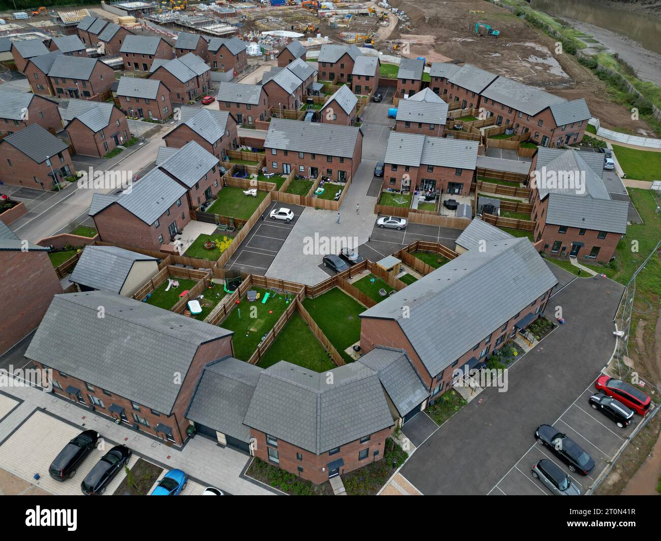 Aerial drone view of new housing under construction alongside newly