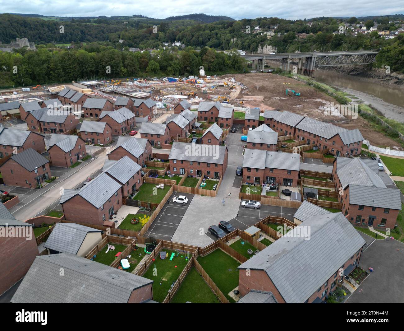 Aerial drone view of new housing under construction alongside newly