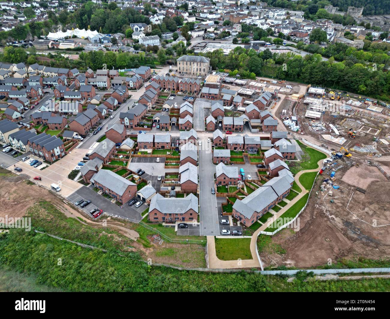 Aerial drone view of new housing under construction alongside newly