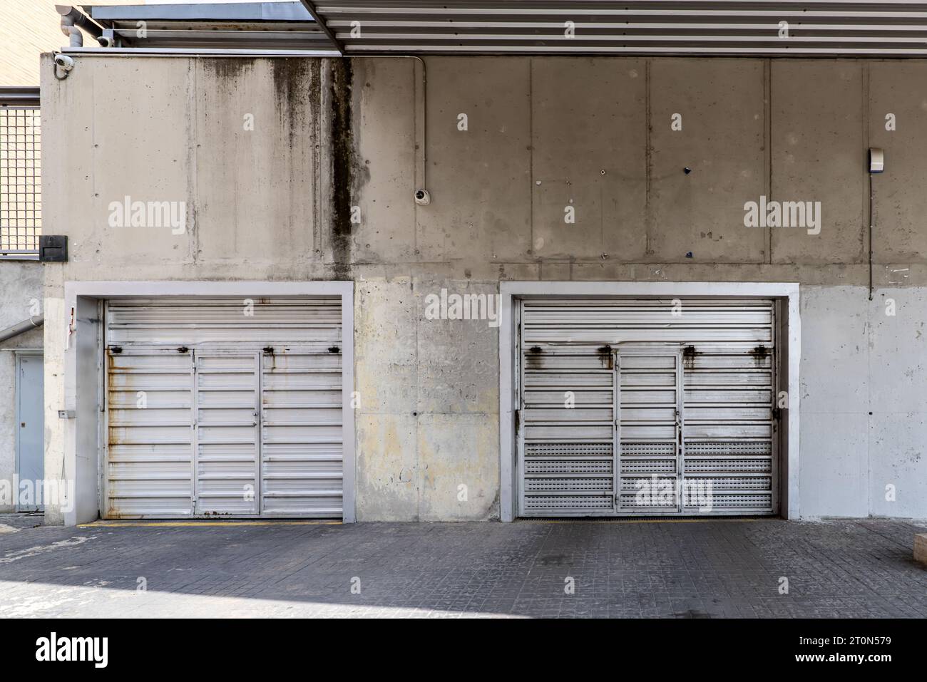 Metal lift access doors to individual garages Stock Photo Alamy