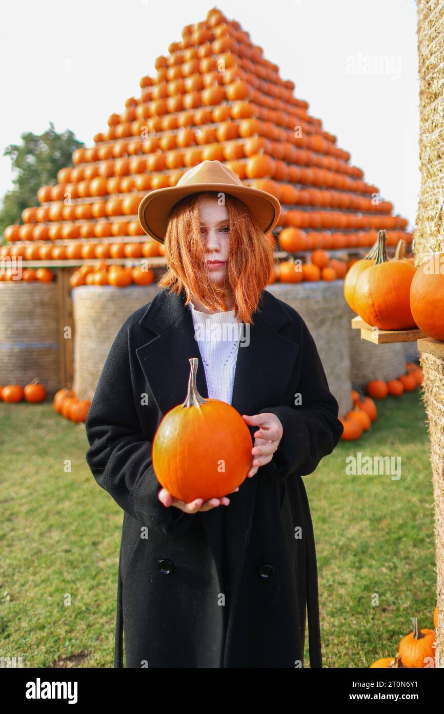 red-haired girl hold pumping in the pumping farm market Stock Photo