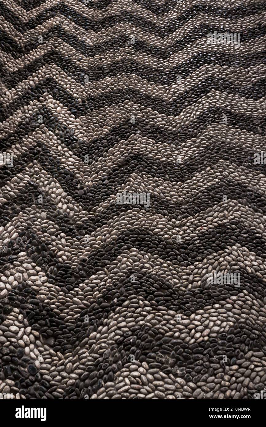 Round cobblestone rocks creating a chevron pattern walking path in The Kahal Shalom Synagogue (Synagogue of the Holy Congregation of Peace) Stock Photo