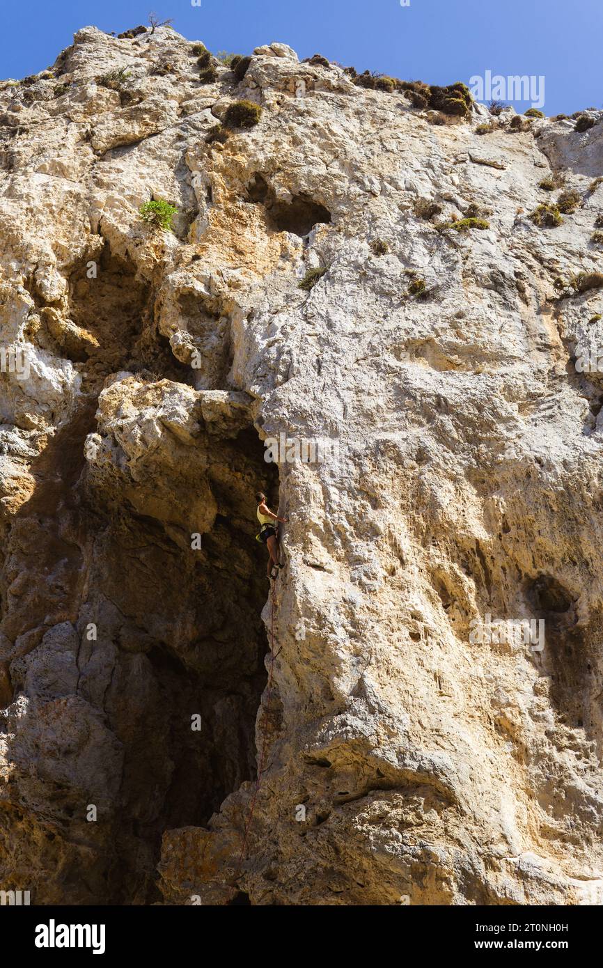 Man climbing through rock hi-res stock photography and images - Alamy