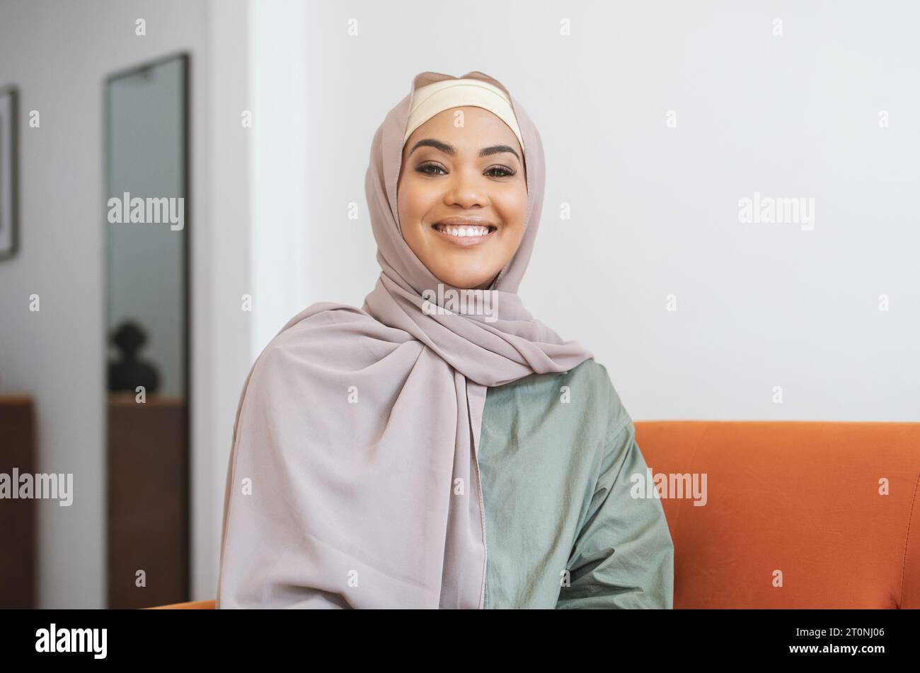 Portrait Of Happy Muslim Woman In Hijab Posing At Home Stock Photo - Alamy