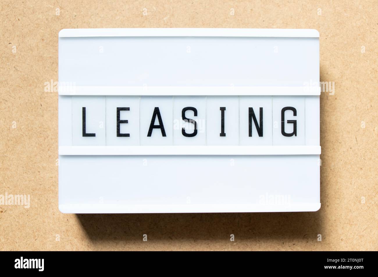 Lightbox with word leasing on wood background Stock Photo
