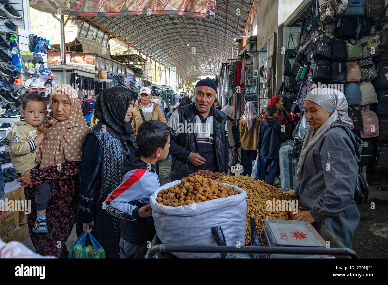 Osh, Kyrgyzstan - October 8, 2023: A woman selling peanuts at the Jayma