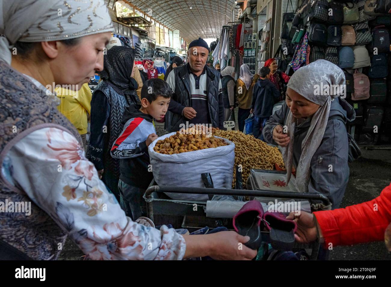 Osh, Kyrgyzstan - October 8, 2023: A woman selling peanuts at the Jayma