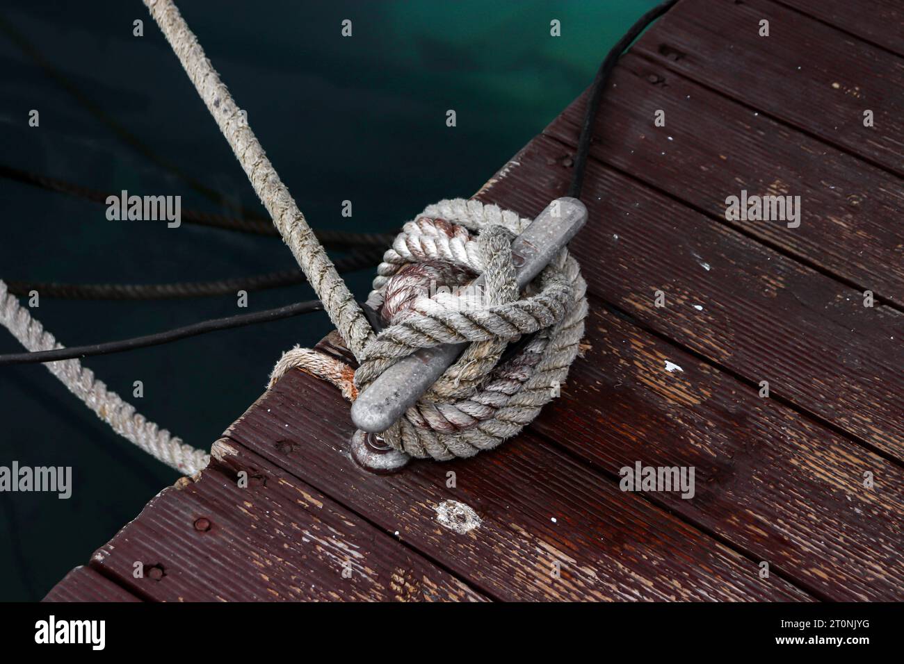 Marine Mooring Bollard anchoring a sailboat using twisted polyester rope Stock Photo