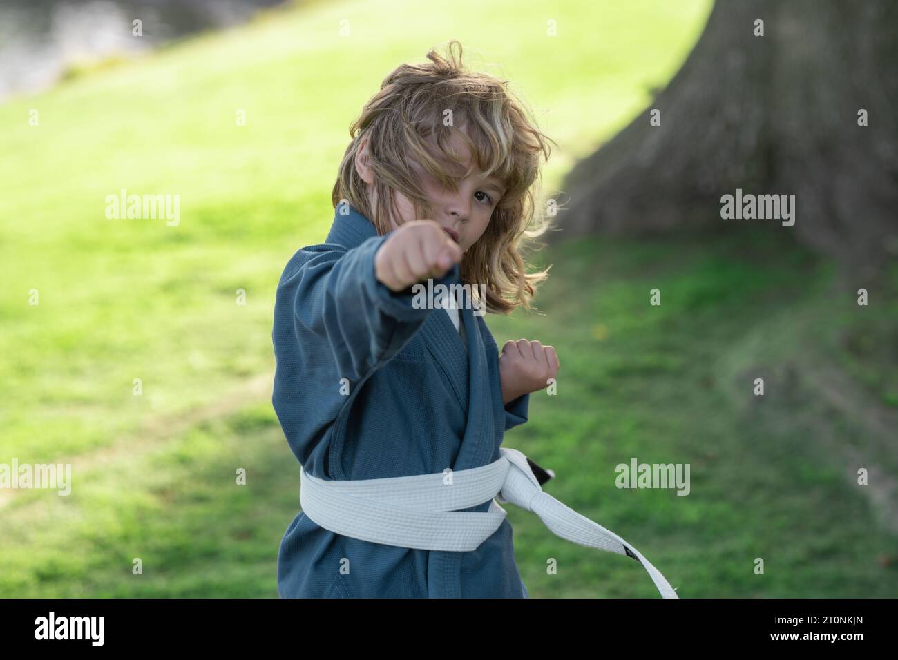 Kid boy practicing martial arts outdoor. Sport martial arts kids. Little boy wearing kimono