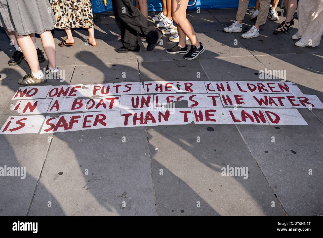 Message about immigration, reading “No one puts their children in a boat unless the water is safer than the land”. Paris, France, Europe, EU Stock Photo