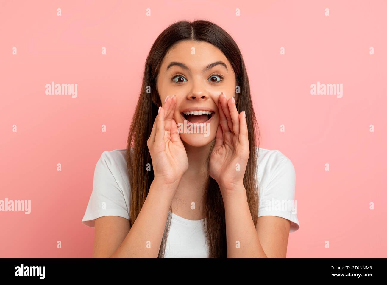 Hey You. Cheerful Teen Girl Keeping Hands Near Mouth And Making Announcement Stock Photo