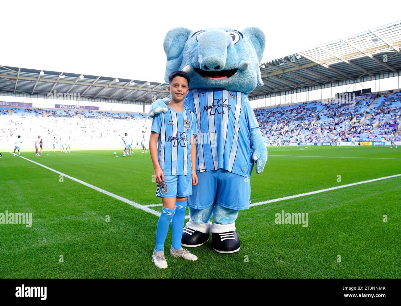 A Coventry City match day mascot poses for a photo with Sky Blue Sam